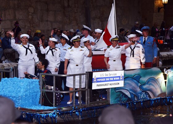 SAN ANTONIO – (April 24, 2023) – Rear Adm. Cynthia Kuehner, commander of Naval Medical Forces Support Command (NMFSC), joined by Sailors and Coast Guardsmen representing the sea services, participated in the annual Texas Cavaliers River Parade at the San Antonio River Walk during Fiesta San Antonio. The grand marshal of the river parade was former NASA Astronaut, retired U.S. Air Force Reserve Brig. Gen. Charles M. Duke Jr., who is the youngest astronaut to walk on the moon at the age of 36 during the Apollo 16 mission in April of 1972. Apollo 16 was the first scientific expedition to inspect, survey, and sample materials and surface features in the Descartes region of the rugged lunar highlands of the moon. The river parade featured over 50 festively decorated floats with live music and costumed crews.  San Antonio is a 11-day annual celebration featuring parades, exhibits, music, entertainment, and family-friendly fun - all benefitting local, non-profit causes. NAMRU San Antonio’s mission is to conduct gap driven combat casualty care, craniofacial, and directed energy research to improve survival, operational readiness, and safety of Department of Defense personnel engaged in routine and expeditionary operations. It is one of the leading research and development laboratories for the U.S. Navy under the DoD and is one of eight subordinate research commands in the global network of laboratories operating under the Naval Medical Research Command in Silver Spring, Md. (U.S. Navy photo by Burrell Parmer, NAMRU San Antonio Public Affairs/Released)