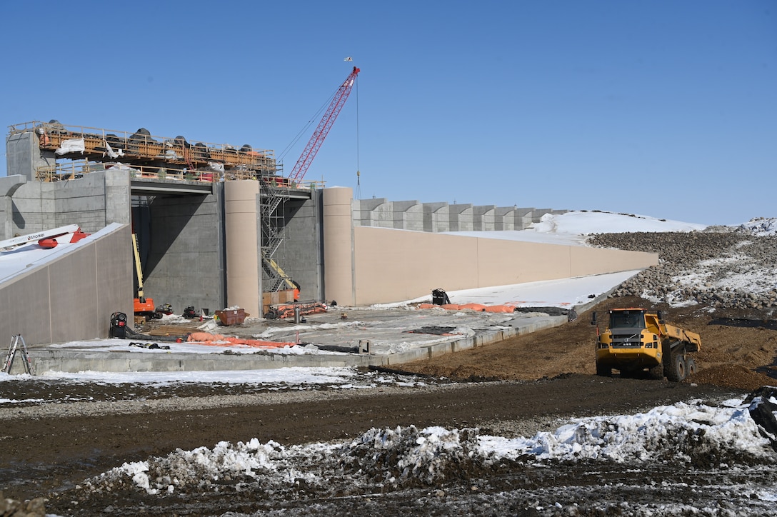 A construction site with a large concrete structure.