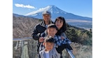a family of four with Mt. Fuji in background