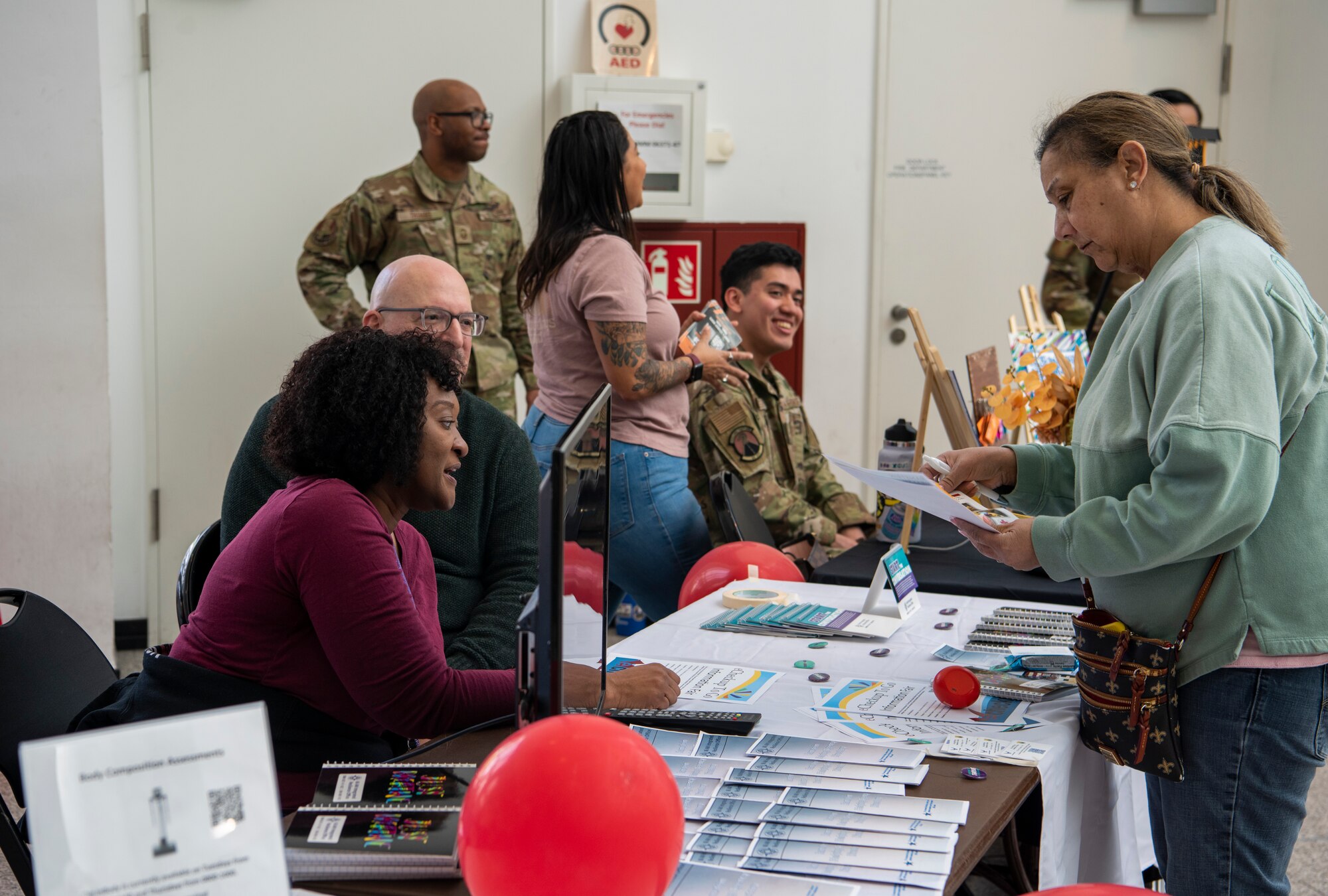 Lashanda Palmer, left, 86th Airlift Wing violence prevention integrator, discusses available resources with a visitor during an e-CheckUptoGo information fair at Ramstein Air Base, Germany, April 27, 2023.