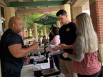 Man handing out pamphlets to couple.