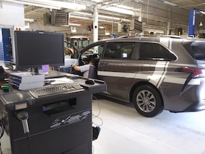 A rideshare van undergoes air emissions testing at the Hill Air Force Base Auto Hobby Shop in Utah.