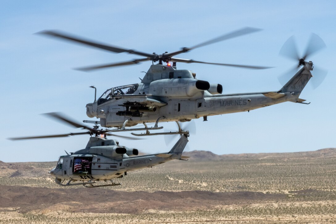 A U.S. Marine Corps AH-1Z Viper and a UH-1Y Venom, with Marine Light Attack Helicopter Squadron (HMLA) 367, Marine Aircraft Group 39, 3rd Marine Aircraft Wing, conduct training during National Training Center Rotation 23-07 at Fort Irwin, California, April 27, 2023. During the exercise, HMLA-367 supported 75th Ranger Regiment and 3/160th Special Operations Aviation Regiment (SOAR) as the sole rotary-wing fire support element, enhancing joint planning and execution of long-range assault force escort, deep and close air support, and direct-action raids. (U.S. Marine Corps photo by Lance Cpl. Devereux)