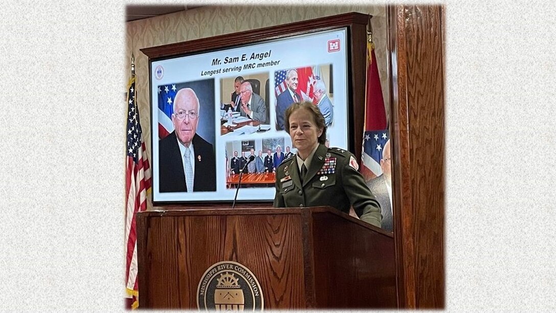 Female military officer in uniform, standing behind a podium