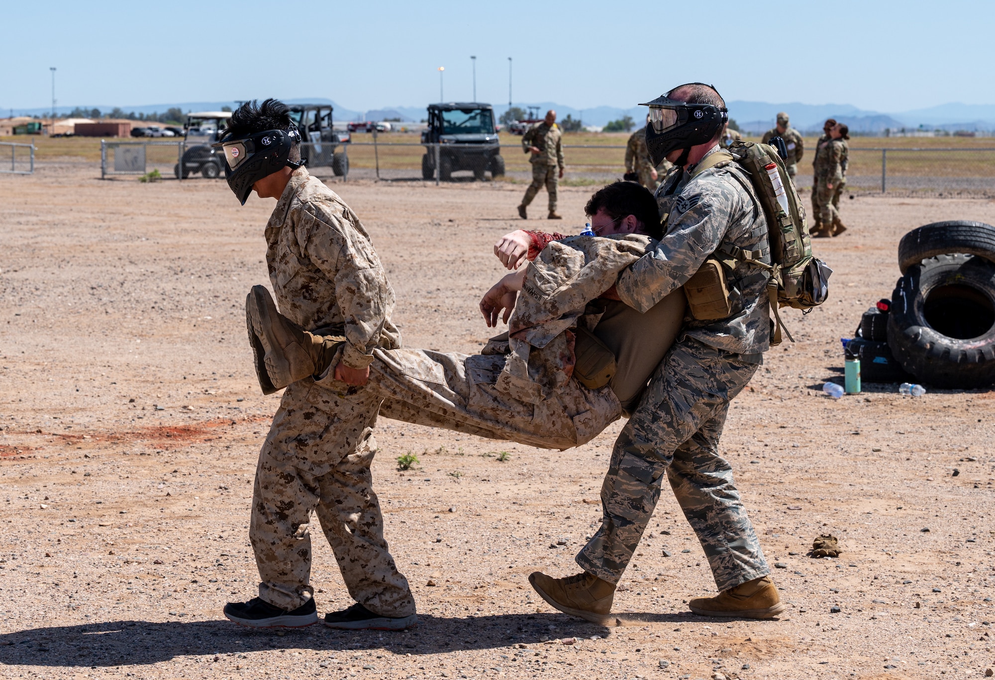 U.S. Air Force 1st Lt. Shane Mikolajewki, 81st Medical Group healthcare specialist (right), carries a simulated patient during a Tactical Combat Casualty Care exercise April 26, 2023, at Luke Air Force Base, Arizona.