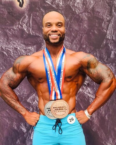 U.S. Air Force Master Sgt. Michael Joyner, 355th Force Support Squadron fitness flight section chief, poses with his medals at the 2022 Dennis James Classic in Scottsdale, Ariz., June 25, 2022. Joyner competed in the men’s physique category and won second place. (Courtesy photo)