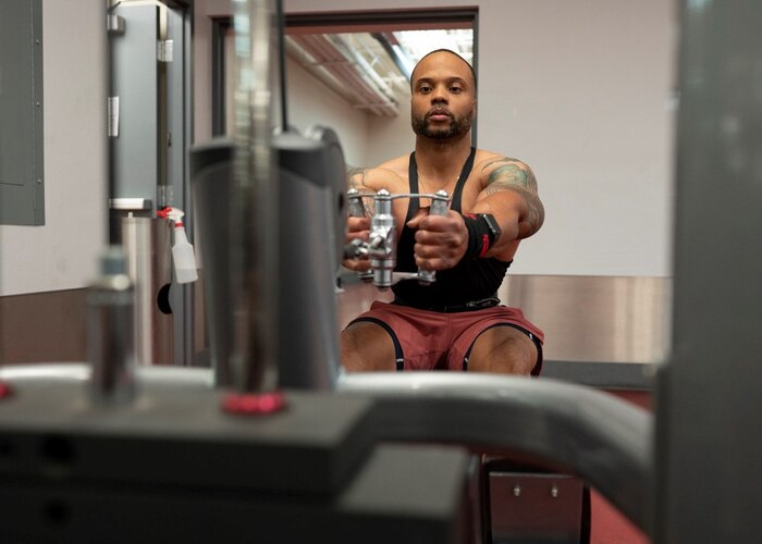 U.S. Air Force Master Sgt. Michael Joyner, 355th Force Support Squadron fitness flight section chief, works out on a rowing machine in the Haeffner Fitness Center at Davis-Monthan Air Force Base, Ariz., April 25, 2023. Joyner trains often to compete in men’s physique competitions. (U.S. Air Force photo by Airman William Finn)