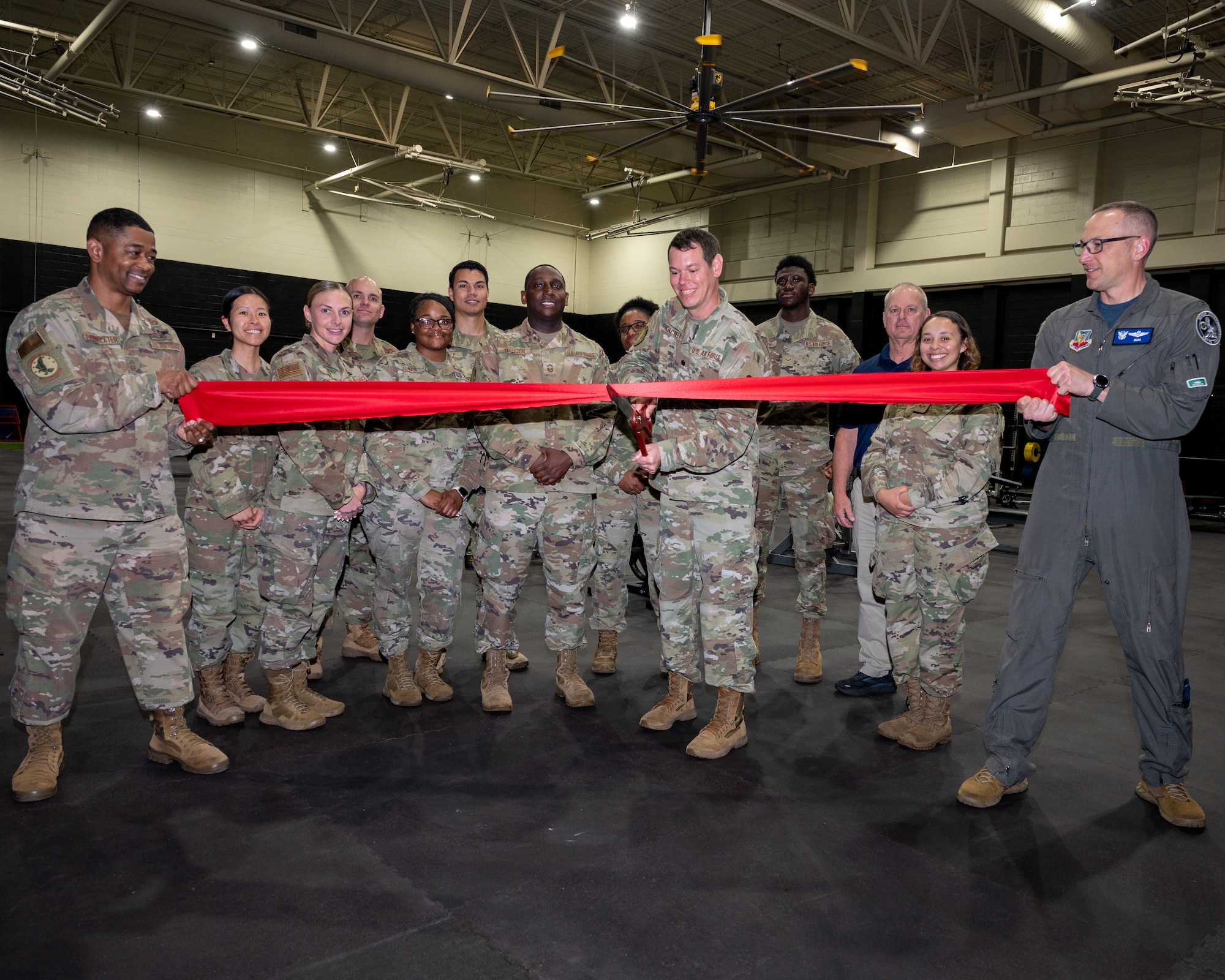 U.S. Air Force Col. Steven M. Bofferding, far right, 4th Fighter Wing vice commander, assists Lt. Col. Timothy Kirchner, center, 4th Force Support Squadron commander, and members of the 4th Mission Support Group, cut a ribbon during the Seymour Johnson Fitness Center's Multi-Functional Fitness Room ribbon cutting ceremony at Seymour Johnson Air Force Base North Carolina, April 4, 2023. The ribbon cutting was for the re-opening of a newly renovated workout room in the SJAFB Fitness Center.