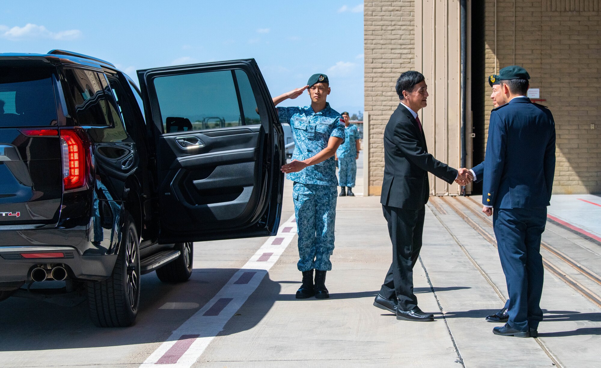 Heng Chee How, Republic of Singapore Senior Minister of State shakes hands with Republic of Singapore Air Force Maj. Gen Kelvin Khong, Republic of Singapore Chief of Air Force, upon arrival to the 425th Fighter Squadron, April 25, 2023, at Luke Air Force Base, Arizona