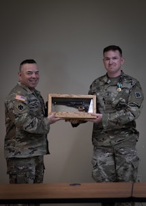 Command Sgt. Major John Hernandez (left), state command sergeant major for Oklahoma, and Sgt. Evan Bias, a cavalry scout assigned to 1st Squadron, 180th Cavalry Regiment, pose at the awards ceremony for the 2023 Best Warrior Competition at Camp Gruber Training Center, Oklahoma, April 23. The annual competition brings Soldiers together to demonstrate their proficiency in a variety of warrior tasks and drills such as land navigation, marksmanship, an obstacle course, and a 12-mile ruck march, all culminating in an interview with a panel of sergeants major. (Oklahoma National Guard photo by Spc. Danielle Rayon)