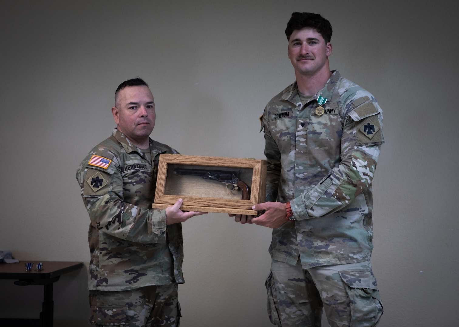 Command Sgt. Major John Hernandez (left), state command sergeant major for Oklahoma, and Spc. Carson Downum, a horizontal construction engineer assigned to the 120th Engineer Battalion, 90th Troop Command, Oklahoma Army National Guard, pose at the awards ceremony for the 2023 Best Warrior Competition, Camp Gruber Training Center, Oklahoma, April 23. The annual competition brings Soldiers together to demonstrate their proficiency in a variety of warrior tasks and drills such as land navigation, marksmanship, an obstacle course, and a 12-mile ruck march, all culminating in an interview with a panel of sergeants major. (Oklahoma National Guard photo by Spc. Danielle Rayon)