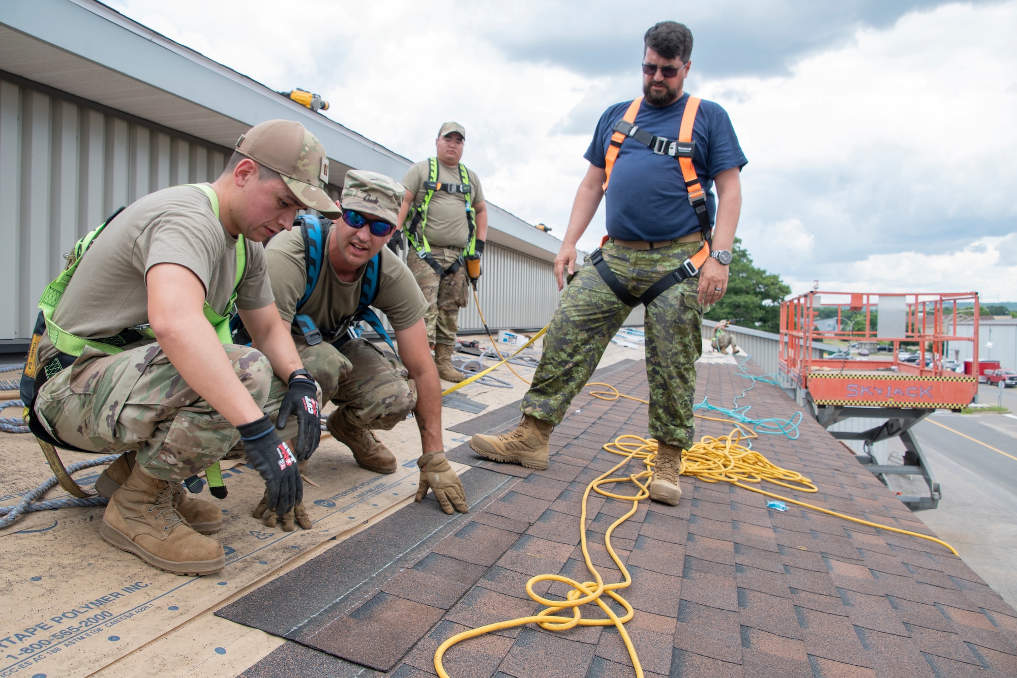 U.S. Air National Guard members with the 131st Bomb Wing resurface a roof with the assistance of Master Corporal Shantz Hallman, Royal Canadian Air Force (RCAF) construction technician, at 14 Wing Royal Canadian Air Force Base in Greenwood, Canada, July 14, 2022. Members with the 131st Bomb Wing’s 231st Civil Engineer Squadron, 200th REDHORSE Squadron and the 239th Combat Communications Squadron, deployed to Nova Scotia as part of the Construction Engineering Project Exchange Program with the 14 Wing of the RCAF. These Guard members worked in cooperation with the RCAF to complete quality of life improvements to the base, to build on skillsets and to strengthen interoperability with Canadian allies. (U.S. Air National Guard photo by Airman 1st Class Kelly C. Ferguson)