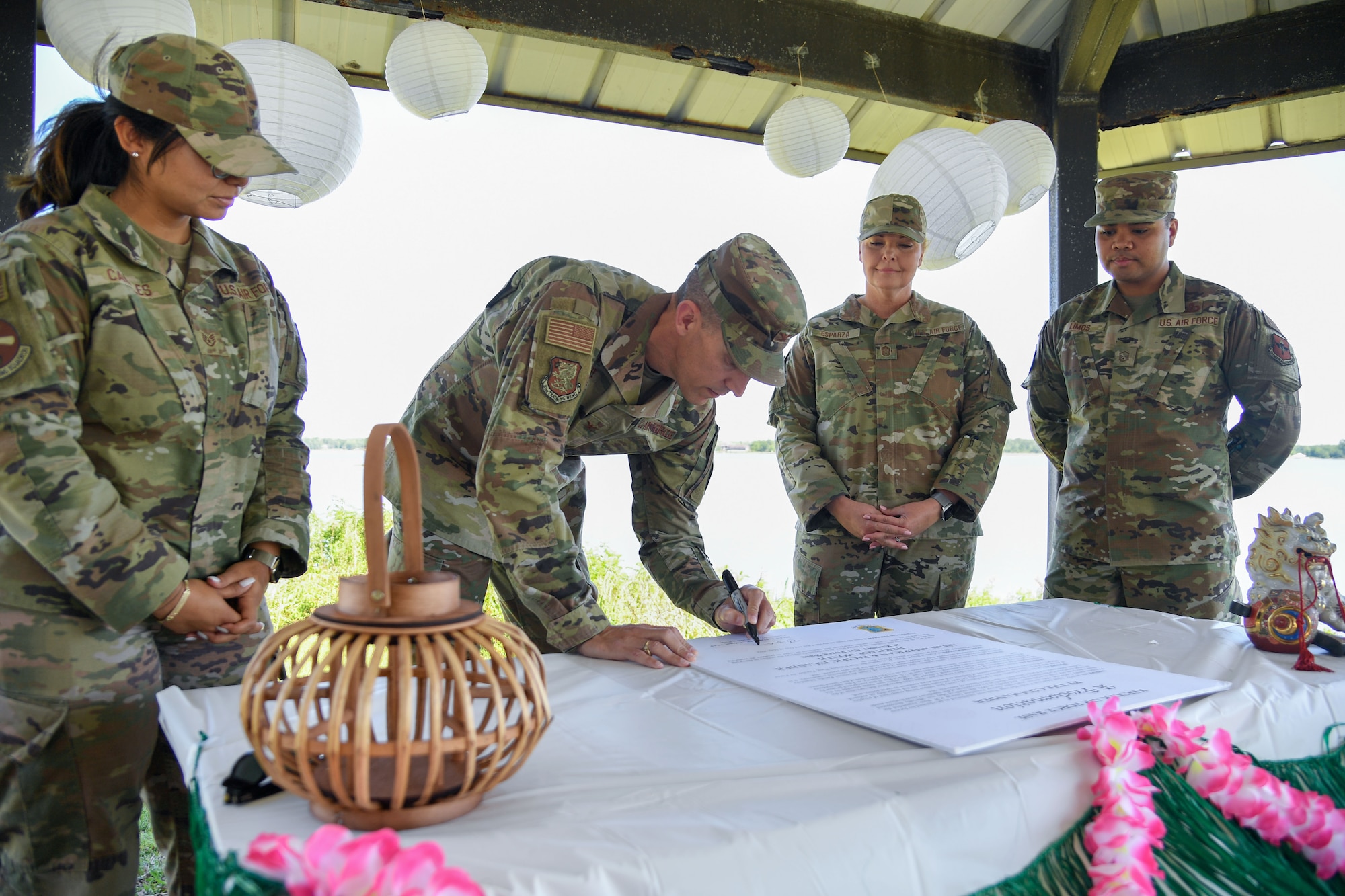 U.S. Air Force Col. Billy Pope, 81st Training Wing commander, signs the Asian American & Pacific Islander Heritage Month Proclamation at the marina park at Keesler Air Force Base, Mississippi, May 2, 2023.