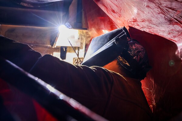 A Joint Task Force-Red Hill (JTF-RH) contractor welds a support beam during repairs in Halawa, Hawaii, April 25, 2023. JTF-RH is in phase three of its five-phase defueling plan. Personnel are focused on completing repairs, quality control tasks, training, response preparation, the National Environmental Policy Act Environmental Assessment, regulatory approvals and operational planning for all major milestones. This extensive preparatory work will help ensure the safe and expeditious defueling of the Red Hill Bulk Fuel Storage Facility. (U.S. Army photo by Sgt. Kyler L. Chatman)