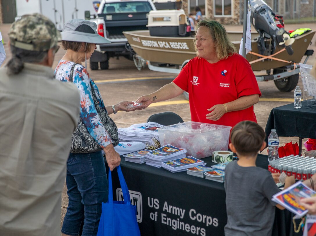 Theresa Conley, with the Galveston District, U.S. Army Corps of Engineers’ (USACE) Emergency Management Division, hands out water safety information to visitors of the Hurricane Hunter Aircraft display at Ellington Airport.