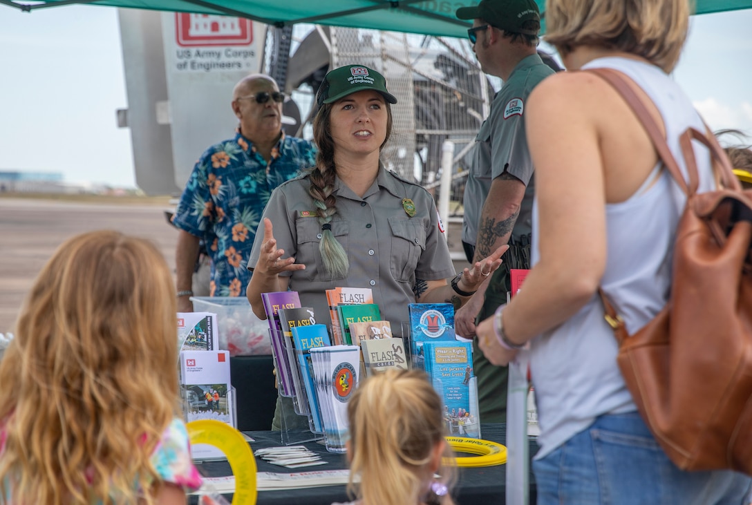 Karly Sias, Park Ranger with the Galveston District, U.S. Army Corps of Engineers (USACE), discusses the district’s role in flood risk management to visitors of the Hurricane Hunter Aircraft display at Ellington Airport.