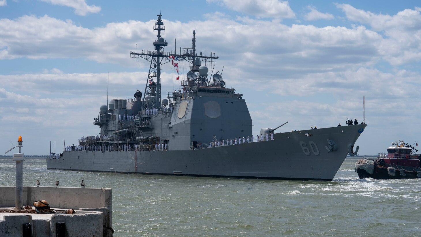 The Ticonderoga-class guided-missile cruiser USS Normandy (CG 60) pulls away from the pier as they depart Naval Station Norfolk for a routine deployment, May 2, 2023.