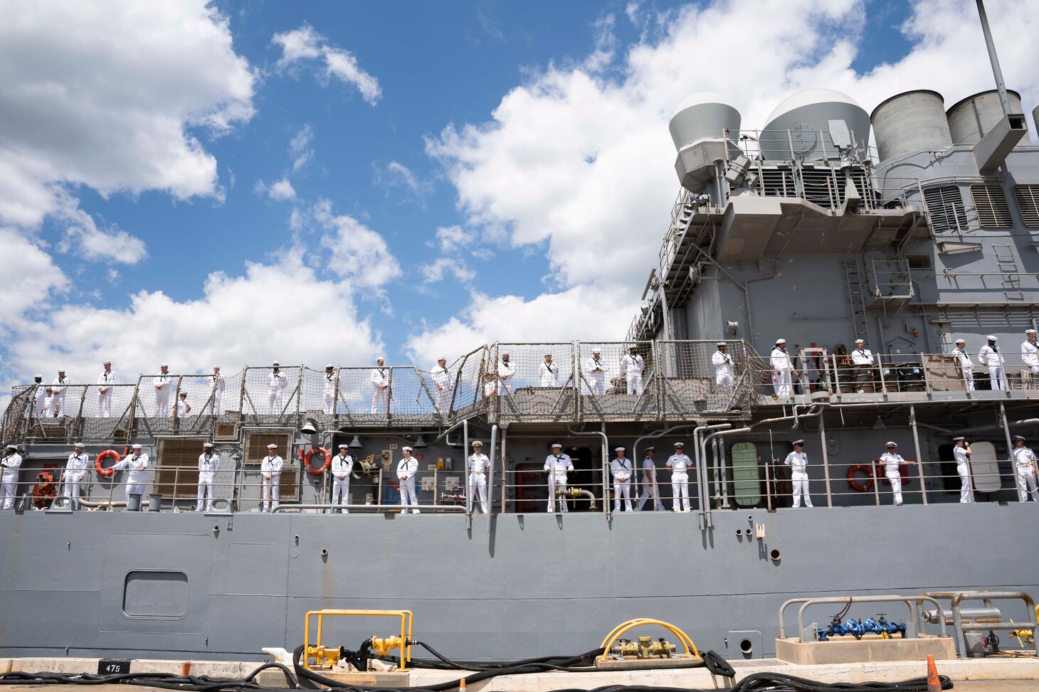 Sailors, assigned to the Ticonderoga-class guided-missile cruiser USS Normandy (CG 60), man the rails as Normandy prepares to depart from Naval Station Norfolk for a routine deployment, May 2, 2023.