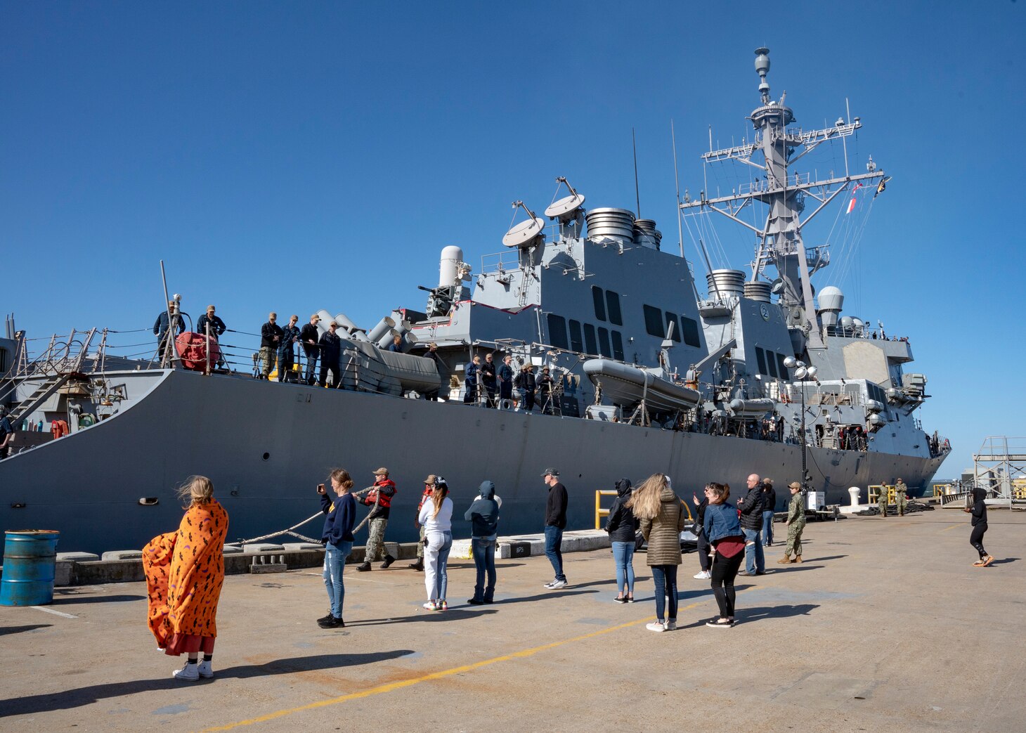 Families of Sailors assigned to the Arleigh Burke-Class guided missile destroyer, USS McFaul (DDG 74), watch as the ship prepares to depart Naval Station Norfolk for deployment, May, 2, 2023.