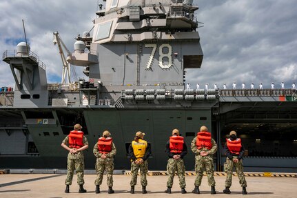 Line handlers stand by as the capital ship of the Gerald R. Ford Carrier Strike Group (GRFCSG), the first-in-class aircraft carrier USS Gerald R. Ford (CVN 78), departs Naval Station Norfolk for a routine deployment, May 2.