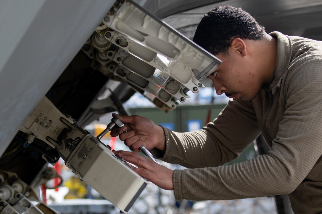 A photo of  an Airmen working on an F-22