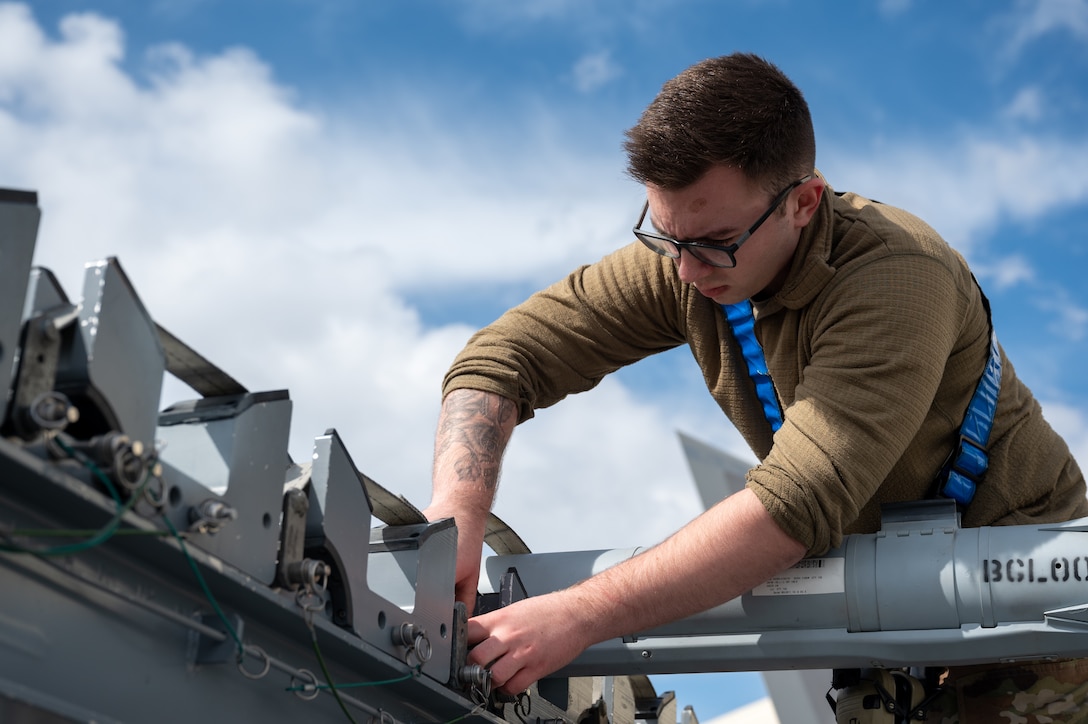 A photo of an Airman inspecting a missile