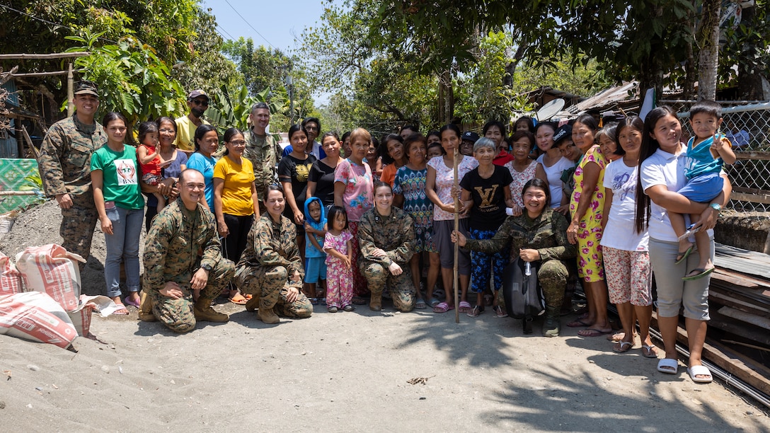 U.S. and Philippine service members and members of the local community pose for a photo after a basic medical class given by Philippine and U.S. service members, as a part of Balikatan 23 in Antique, Philippines, April 17, 2023. Medical personnel with the Armed Forces of the Philippines and the Balikatan Medical Interoperability Training Team taught basic medical classes to local families and members of the community, such as women’s health, dental care, stress management and common diseases, to bring awareness and medical safety to the public. Balikatan, Tagalog for “shoulder-to-shoulder,” is an annual bilateral exercise between the Armed Forces of the Philippines and the U.S. military. The exercise provides unique opportunities for participating forces to increase interoperability and provide tangible benefits for the people of the Philippines. Humanitarian civic assistance projects support local communities in the Philippines and strengthen our partnership. (U.S. Marine Corps photo by Lance Cpl. Sarah Pysher)