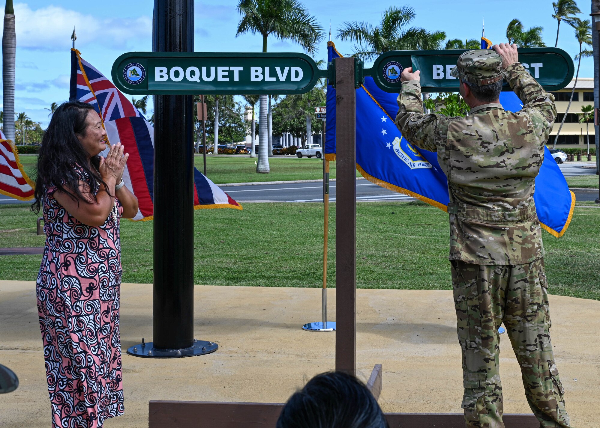 Jessie Higa (left), local volunteer historian, along with Gen. Ken Wilsbach (right), Pacific Air Forces commander, unveil the corrected spelling of “Bedle Street” during a rededication ceremony at Joint Base Pearl Harbor-Hickam, Hawaii, April 26, 2023.