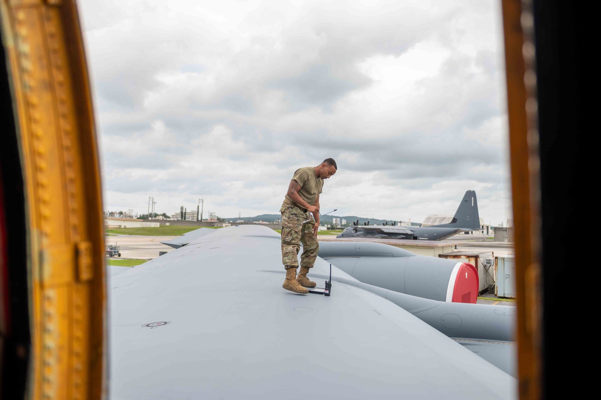 Airman stands on the wing of an aircraft