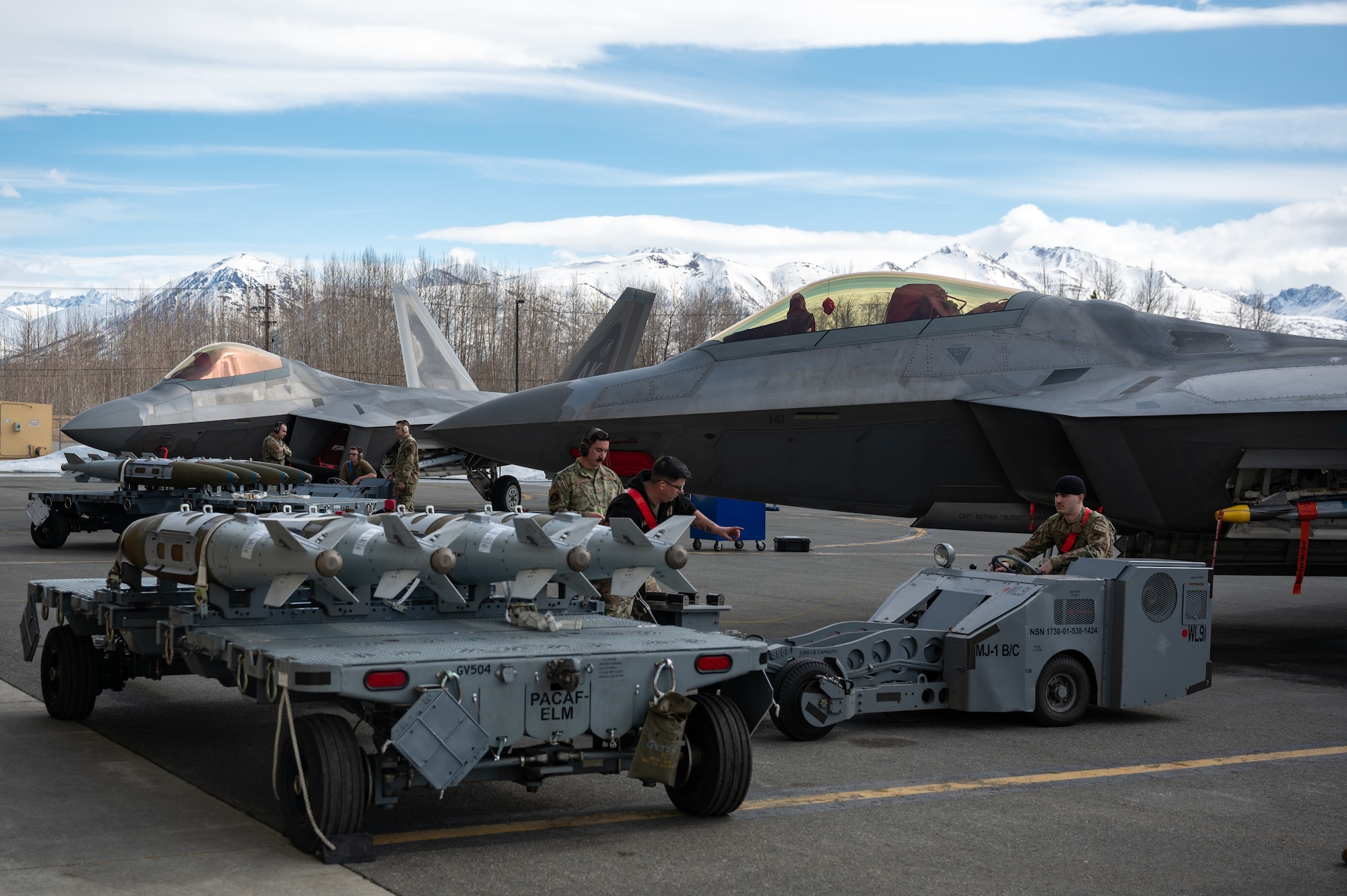 A photo of Airmen competing in a weapons load competition