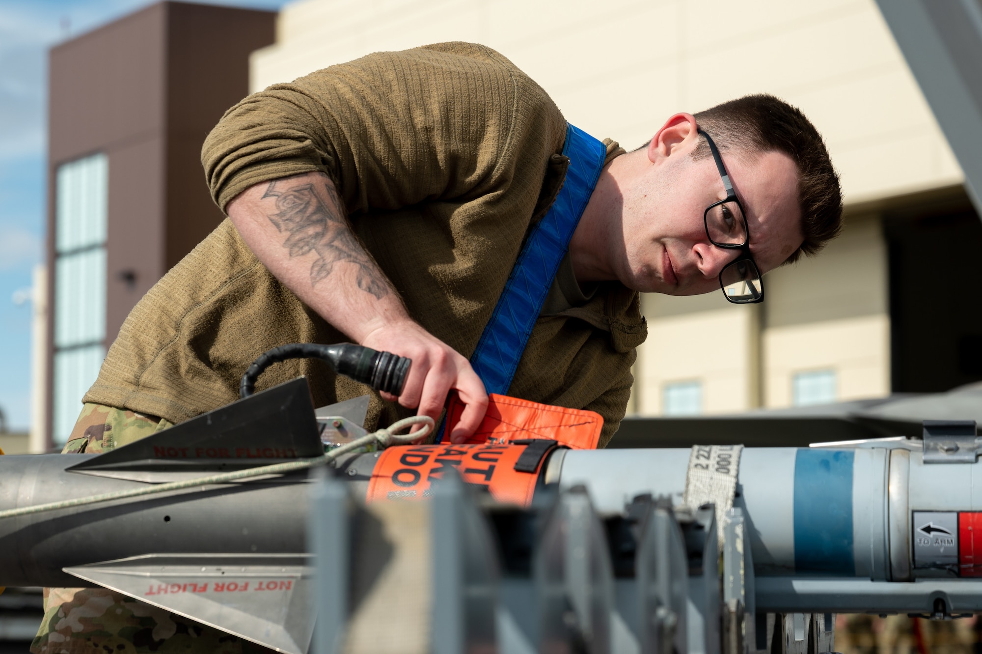 A photo of an Airman inspecting a missile