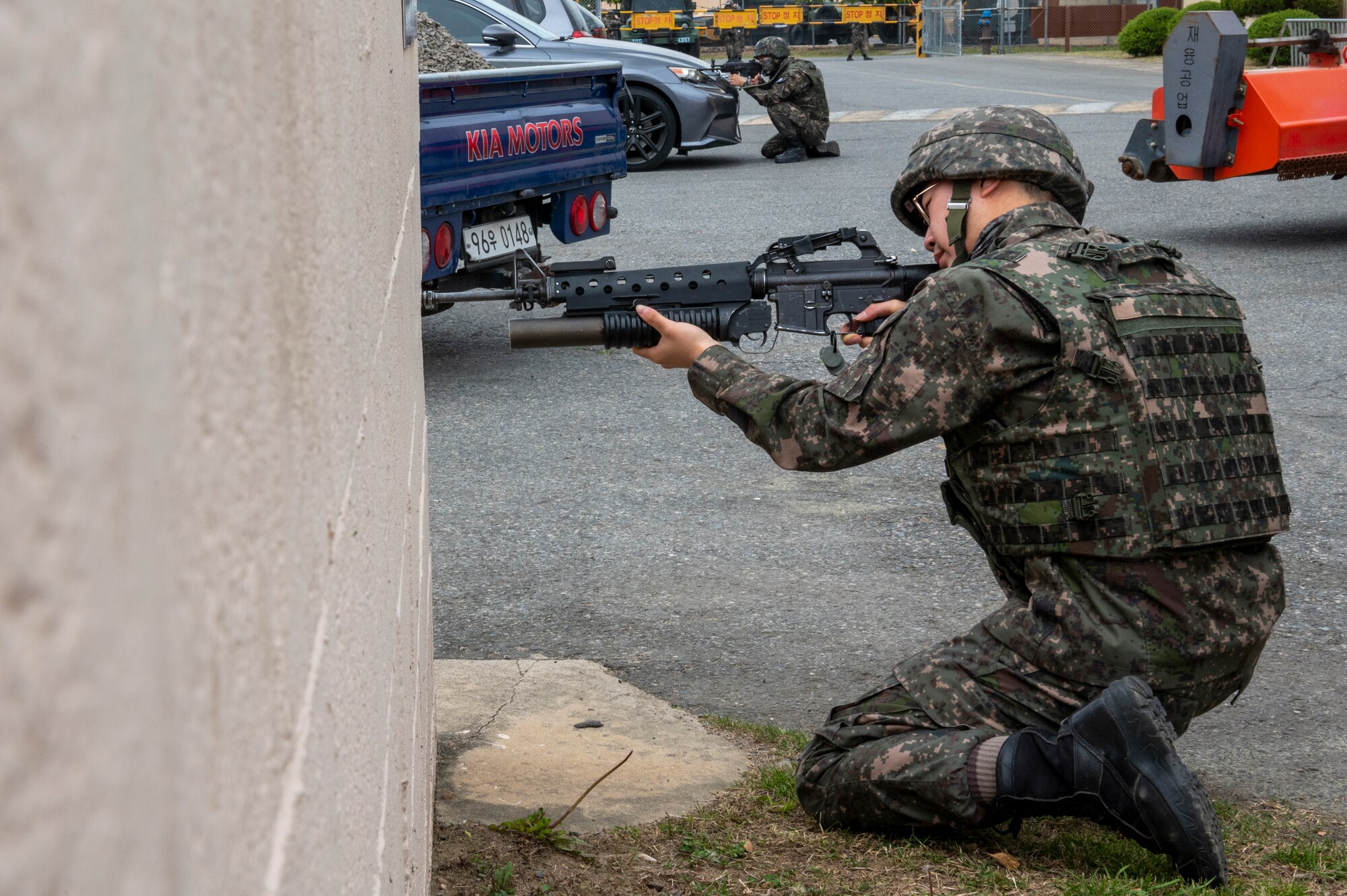 Republic of Korea Air Force military police members hold their position during an active shooter training event at Daegu Air Base, ROK, April 24, 2023. This event tested the base's Ground Operations Center, military police and special duty team’s response capabilities in an active shooter situation. (U.S. Air Force photo by Airman 1st Class Aaron Edwards)