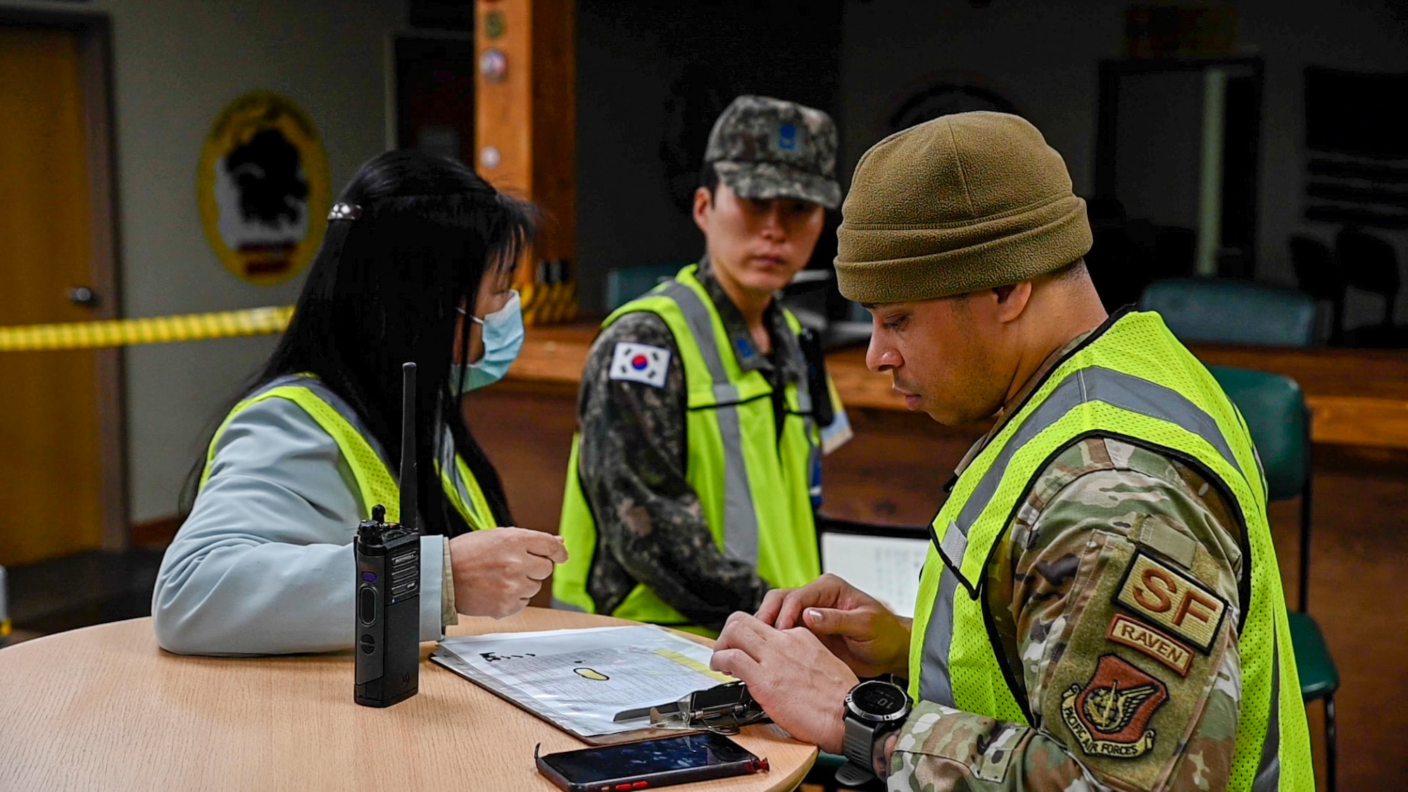 U.S. Air Force Tech Sgt. Charles Bowman Jr., 607th Materiel Maintenance Squadron anti-terrorism program manager, reviews charts with fellow evaluators during an active shooter training event at Daegu Air Base, Republic of Korea, April 24, 2023. During the training, U.S. Air Force members partnered with ROKAF personnel to test capabilities on response and communication, ensuring they have the most efficient airtight operation possible during an active shooter response. (U.S. Air Force photo by Senior Airman Trevor Gordnier)
