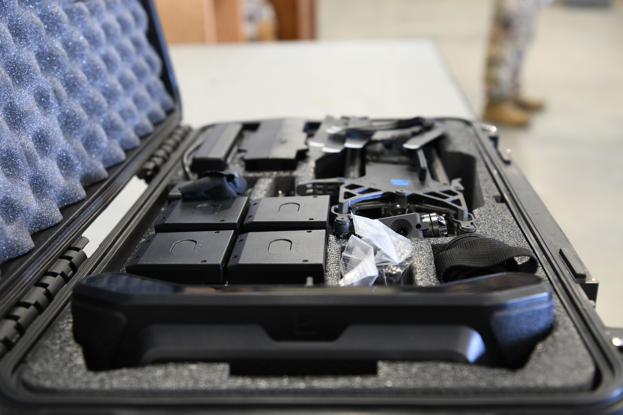 Drone parts rest in a case.