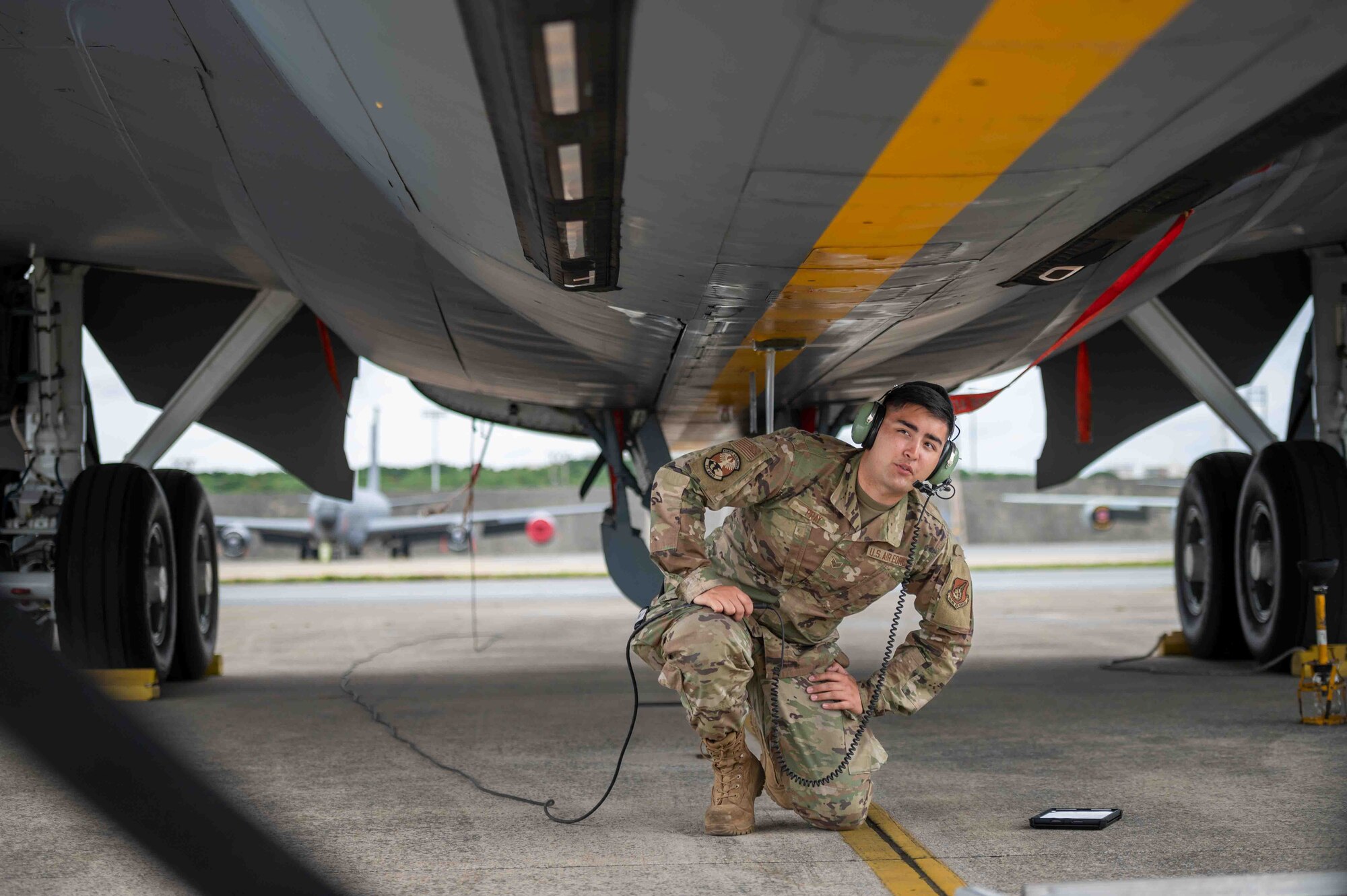Airman inspects the underneath of an aircraft