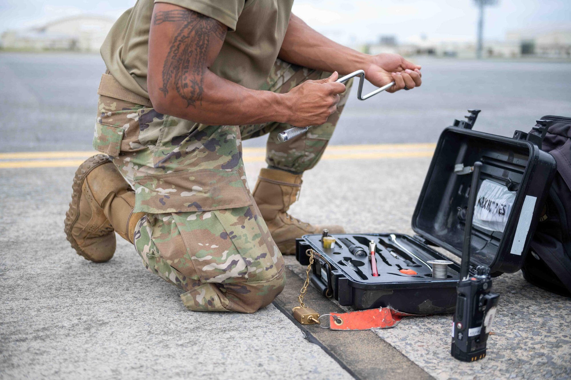 Airman grabs a tool from a toolbox