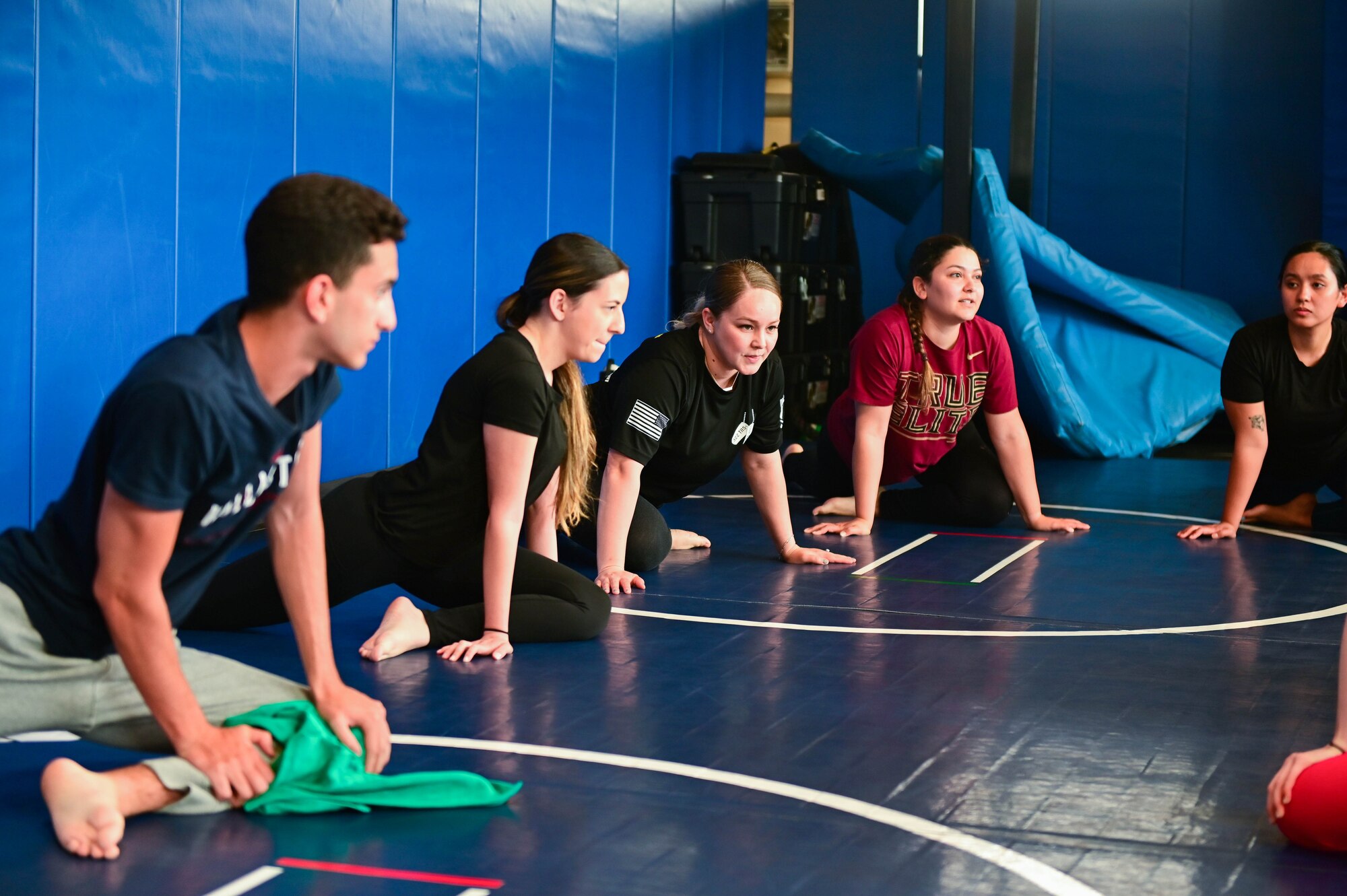 Sexual Assault Awareness Prevention Month Brazilian Jiu-jitsu participants stretch before starting self-defense class.