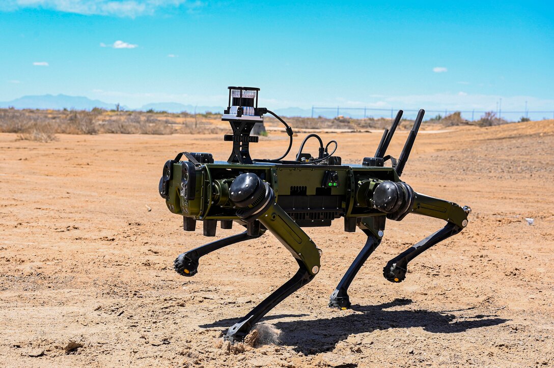 Close-up of an Air Force ground robot standing on desert ground.