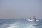 ARABIAN GULF (April 28, 2023) A U.S. Navy P-8A Poseidon flies above U.S. Coast Guard fast response cutters USCGC Emlen Tunnell (WPC 1145), USCGC Glen Harris (WPC 1144) and USCGC Clarence Sutphin Jr. (WPC 1147), April 28, 2023, in the Arabian Gulf during joint training. Emlen Tunnell, Glen Harris and Clarence Sutphin Jr. are deployed to U.S. 5th Fleet to help ensure maritime security and stability in the Middle East region. (U.S. Coast Guard photo by Information Systems Technician 1st Class Vincent Aguirre).