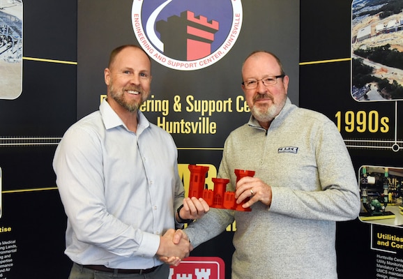 Jason Kirkpatrick, USACE Aviation Integration program manager, left, presents the USACE Castle Award in Aviation to Ryan Strange, a research physical scientist for the USACE Unmanned Aircraft Systems program, May 1. (Photo by Kristen Bergeson)