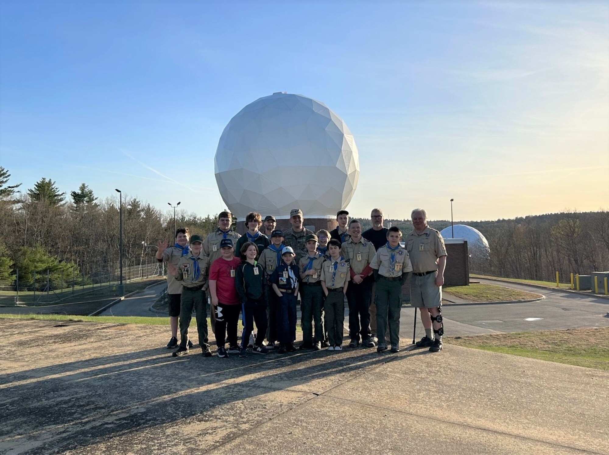 PETERSON SPACE FORCE BASE, Colorado - Members of a local New Hampshire Boy Scouts of America troop and parents pose for a photo in front of a antenna radome at New Boston Space Force Station, New Hampshire. The NBSFS trip was an opportunity for the visiting Scouts to learn more about the Space Force and the mission of the 23rd Space Operations Squadron while also earning credit toward their Space Exploration Merit Badges.