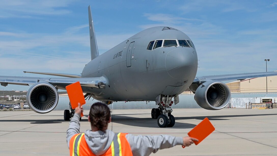 A Boeing maintainer guides a KC-46 Pegasus out of of the flight-line to conduct an air refueling test mission at Edwards Air Force Base, Calif. It is a joint effort between Boeing, Air Mobility Command, Air Force Test Center, 418th Flight Test Squadron and Air Force Life Cycle Management Center to successfully complete the mission.