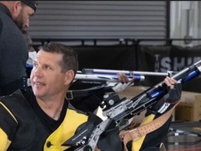 (Photo by Spc. Robert Regan) Sgt. Carl Judd smiles after the first round of air rifle competition at the 2023 Army Adaptive Sports Camp at Fort Bragg NC.