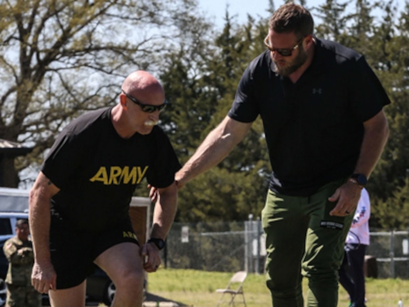 U.S. Army Staff Sgt. Robert Ellison and Coach Tyler Spencer, practice running form during the U.S. Army Adaptive Sports Camp at Fort Bragg, North Carolina, March 30, 2023. Over 70 wounded, ill and injured Soldiers are training in a series of athletic events including archery, cycling, shooting, sitting volleyball, swimming, powerlifting, track, field, rowing, and wheelchair basketball. The Adaptive Sports Camp celebrates wounded, ill, and injured Soldiers ability to recover and overcome. The Army Holds qualifying trials for Active Duty, wounded, ill, or injured Soldiers to assess and select athletes for competition in the DoD Warrior Games Challenge. This year, the DoD Warrior Games Challenge takes place in June 2023 at Naval Air Station North Island in San Diego, California. (U.S. Army photo by Cpl. Anthony Hopper.)