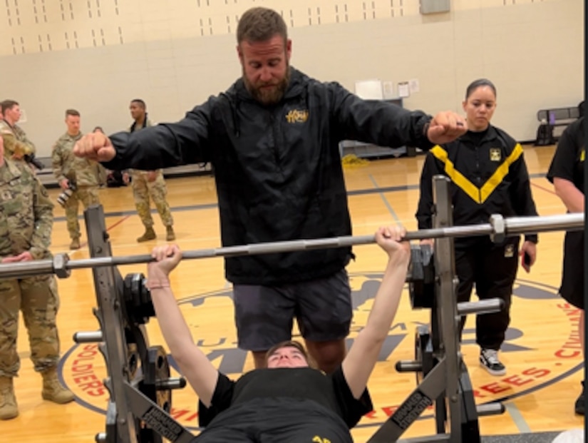 Coach Spencer Tyler instructs Spc Patricia Schjoth in power lifting at the 2023 Army Adaptive Sports Camp at Fort Bragg NC.