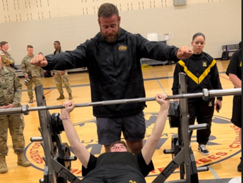 Coach Spencer Tyler instructs Spc Patricia Schjoth in power lifting at the 2023 Army Adaptive Sports Camp at Fort Bragg NC.