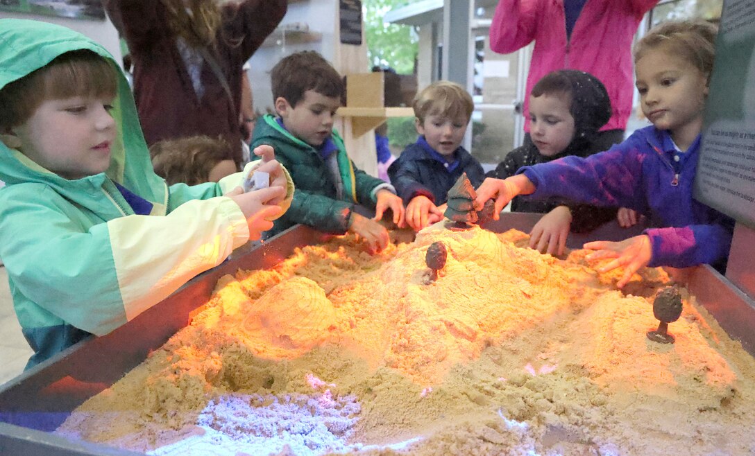 Students check out the interactive sand table in the new Carter Lake Nature Center in Carters Lake, Georgia, April 28, 2023. Carters Lake turned its Nature Center into a state-of-the-art experience for visitors with virtual reality kiosks, interactive games, holographic exhibits.