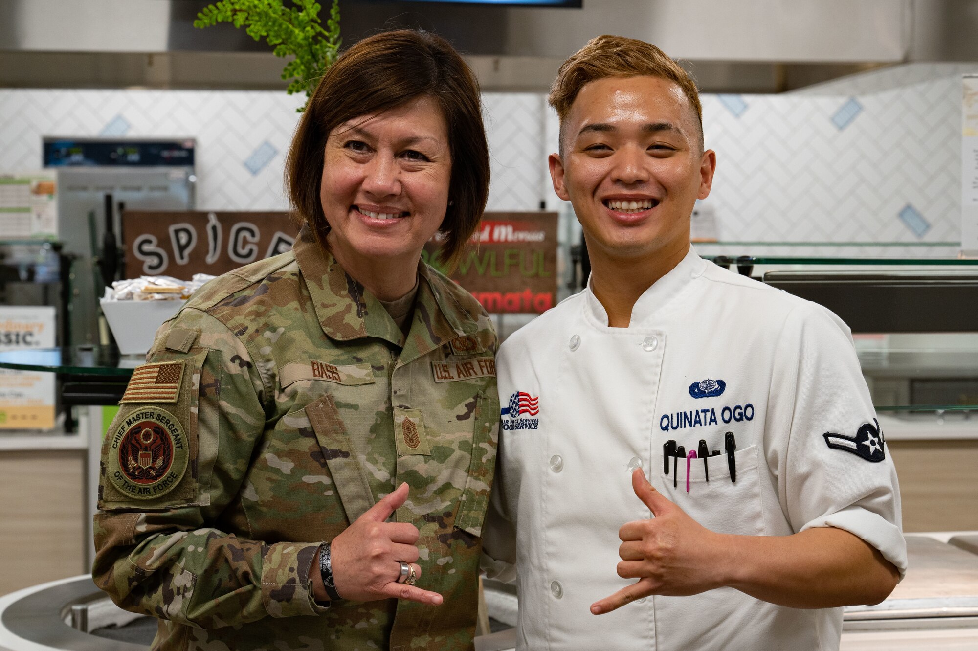 Chief Master Sgt. of the Air Force JoAnne S. Bass, poses for a picture with Airman Gary Quinata Ogo, 99th Force Support Squadron food service specialist, during a visit at Nellis Air Force Base, Nevada, May 2, 2023.