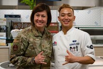Chief Master Sgt. of the Air Force JoAnne S. Bass, poses for a picture with Airman Gary Quinata Ogo, 99th Force Support Squadron food service specialist, during a visit at Nellis Air Force Base, Nevada, May 2, 2023.