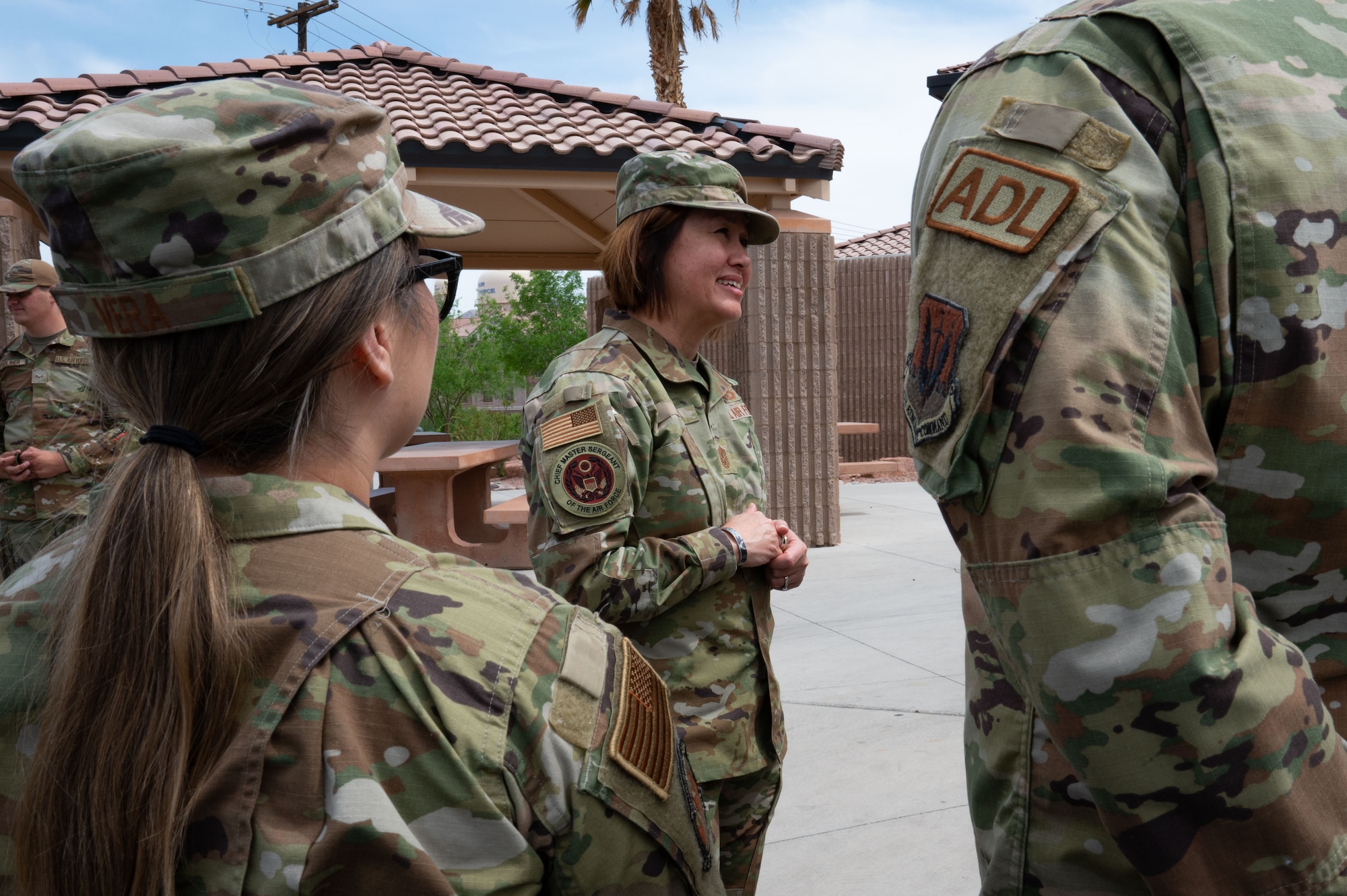 Chief Master Sgt. of the Air Force JoAnne S. Bass, center, speaks with 99th Civil Engineer Squadron Airmen dorm leaders during a visit at Nellis Air Force Base, Nevada, May 2, 2023.